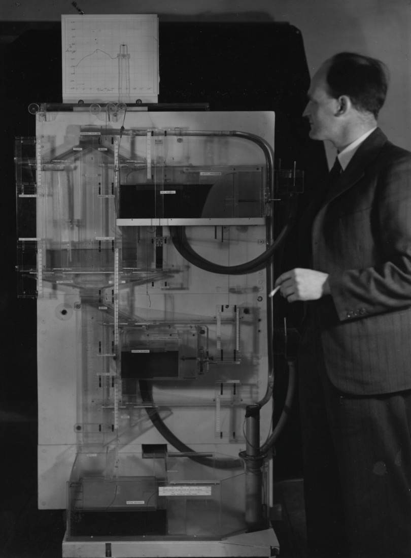 This is Arthur Phillips with the MONIAC machine he built.