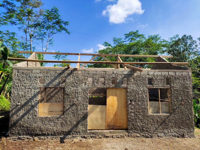 Houses being built ‘brick by brick’ in Ghana (top) and Indonesia (bottom).